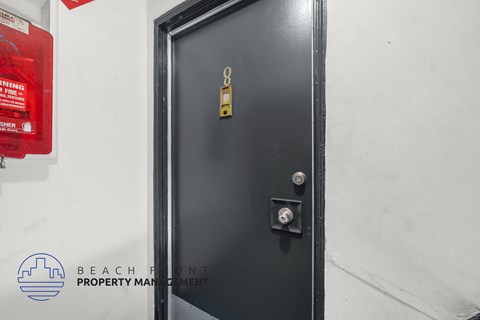 A black door with a gold handle and a key slot.