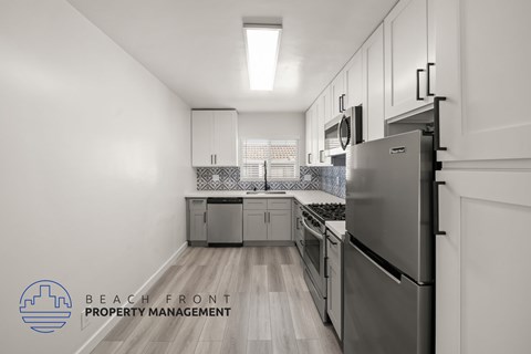 A kitchen with a refrigerator, stove, and oven.