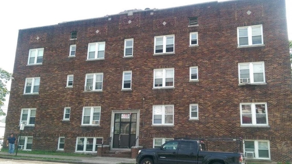 a truck parked in front of a brick building