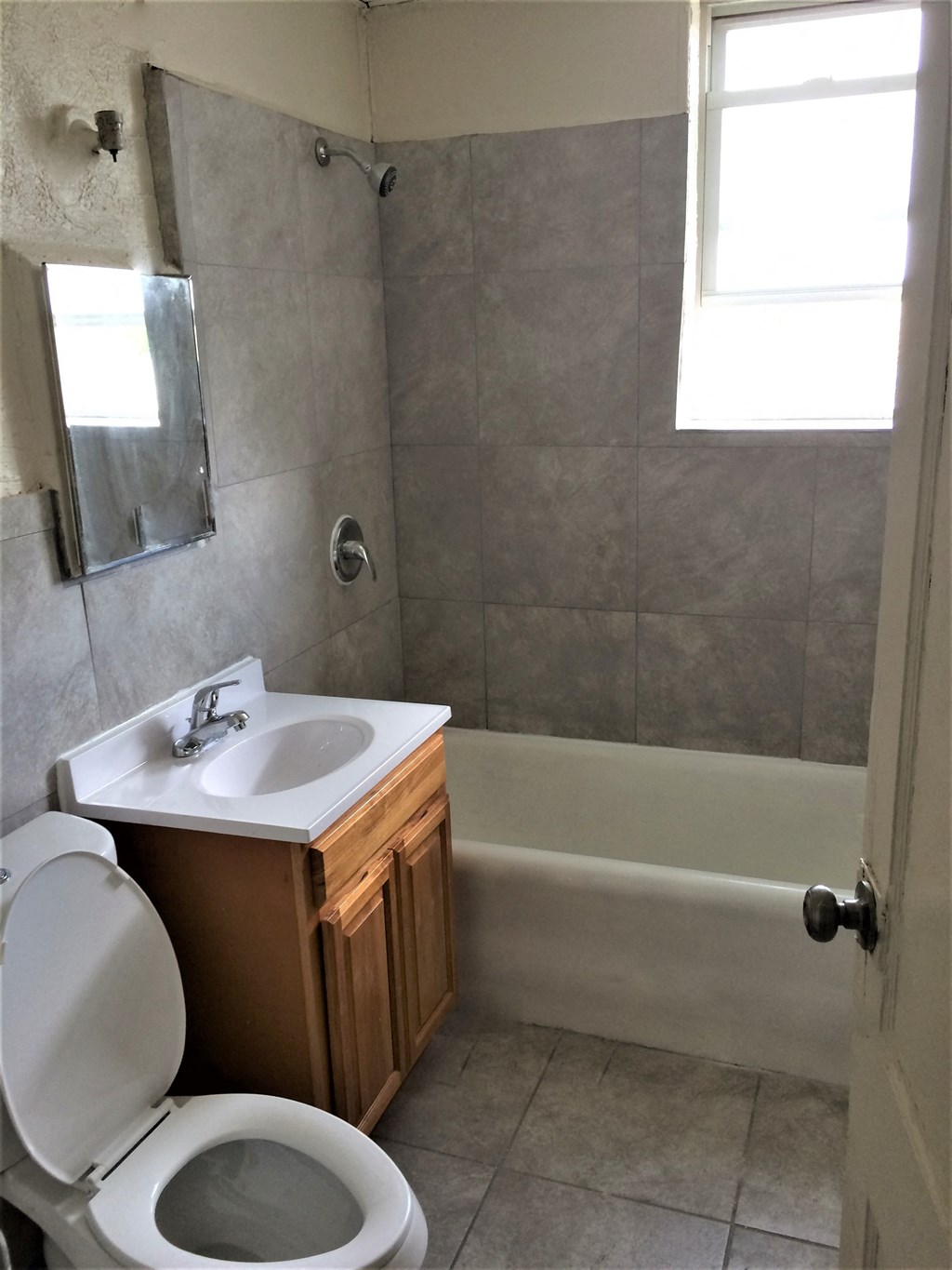 a bathroom with a toilet and a sink and a bath tub
