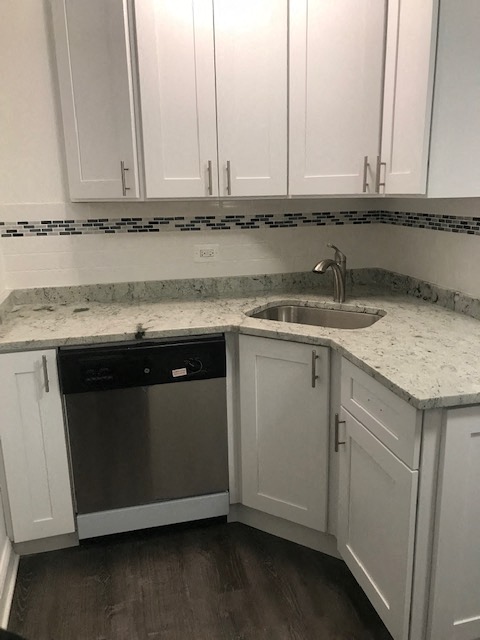 a kitchen with white cabinets and a sink