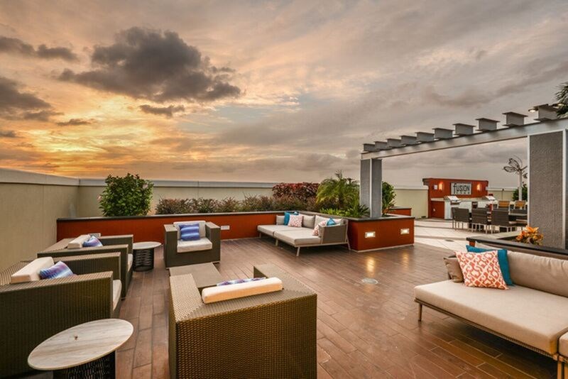 A rooftop patio with a table and chairs.
