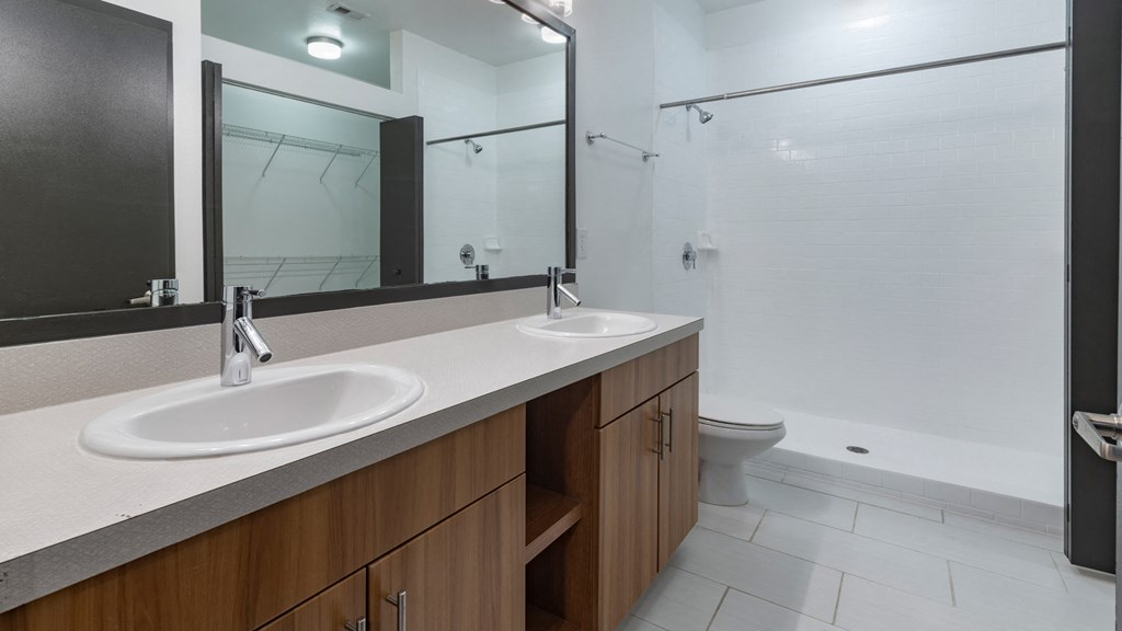 A bathroom with a white sink and a mirror.