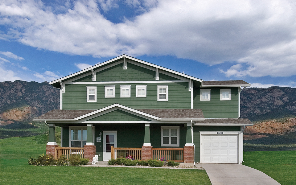 a green house with mountains in the background