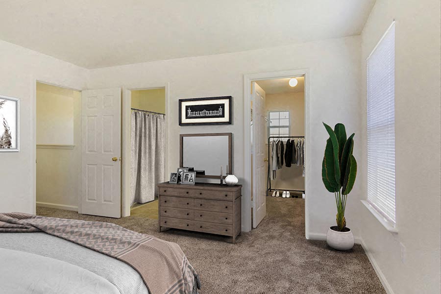 a bedroom with a bed and a dresser and a mirror