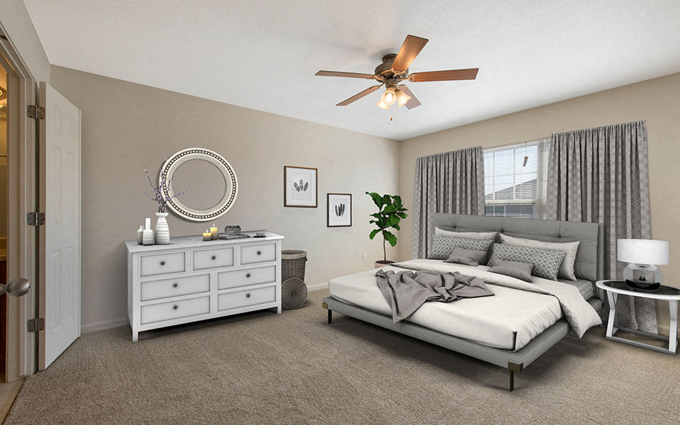 a bedroom with a bed and a ceiling fan