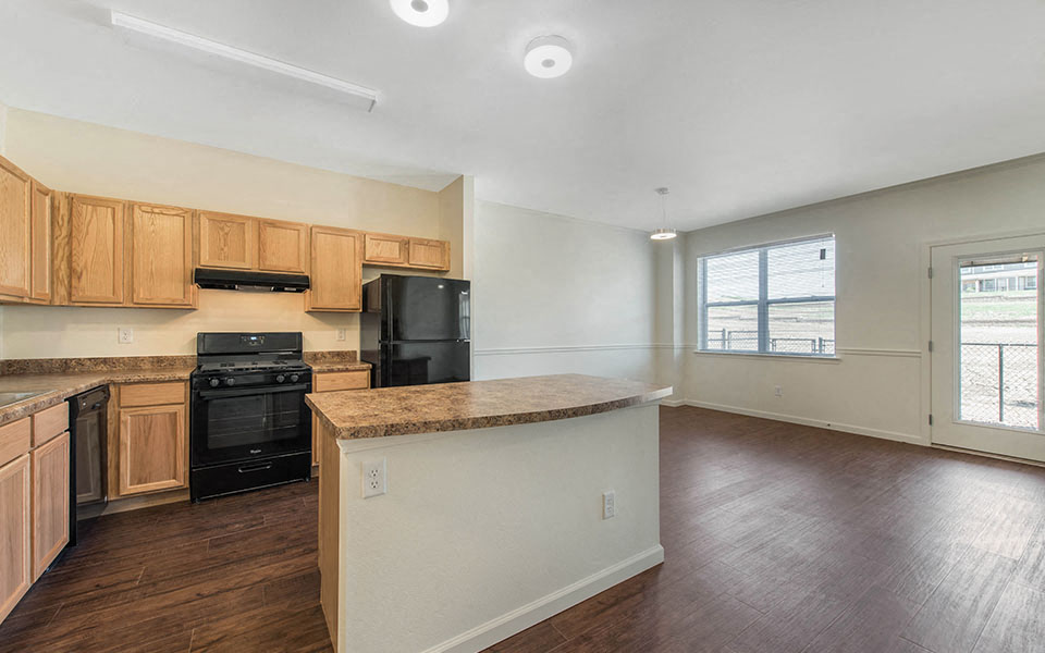 an empty kitchen with a counter top in the middle