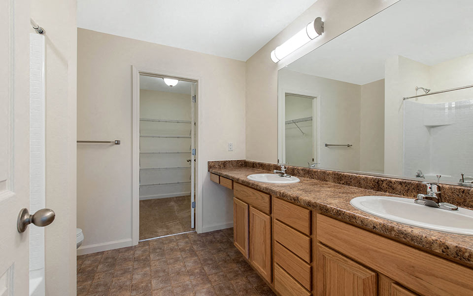 a bathroom with two sinks and a shower