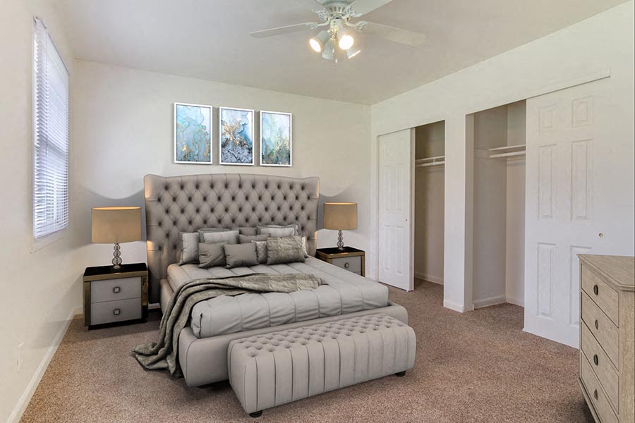 a bedroom with a bed and a ceiling fan