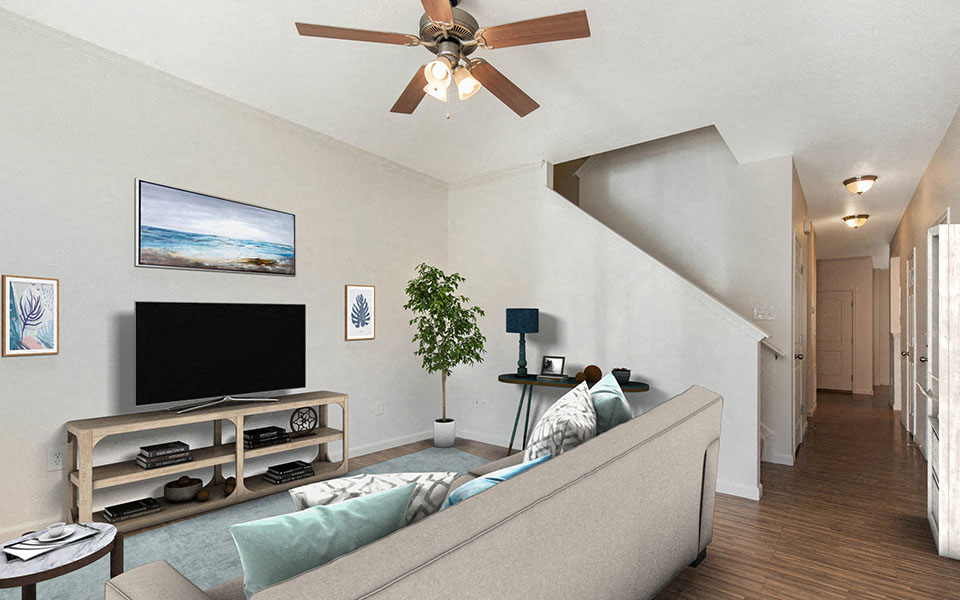 a living room with a couch and a ceiling fan