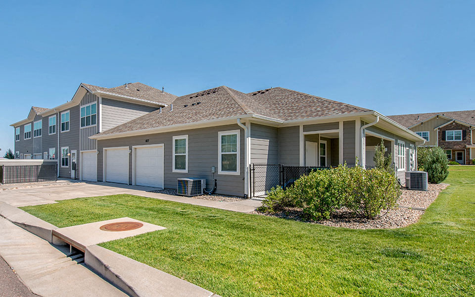 a house with a yard and a sidewalk in front of it