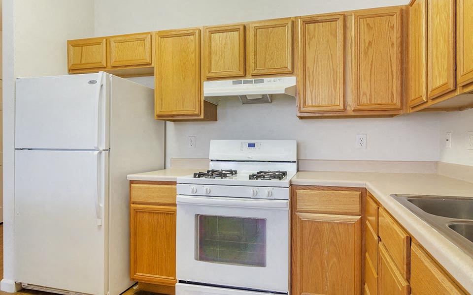 a kitchen with a stove and a refrigerator