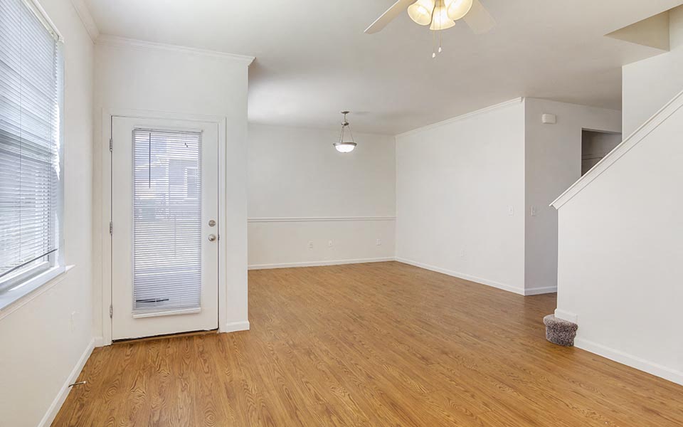 an empty living room with white walls and a white door