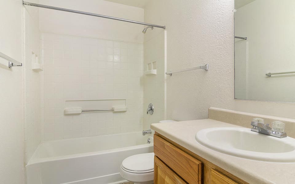 a bathroom with a sink toilet and bath tub
