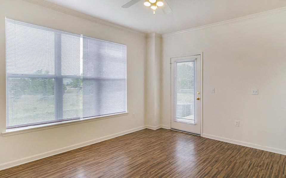 an empty room with a door and a window