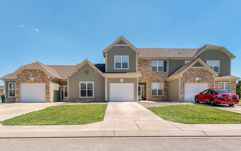 a house with a red car parked in front of it