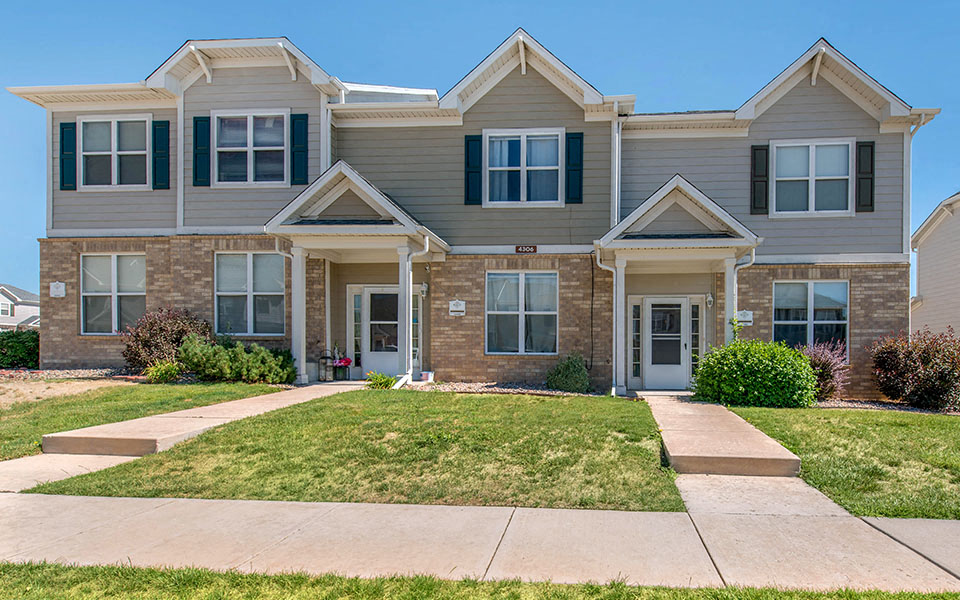 a large house with a sidewalk in front of it