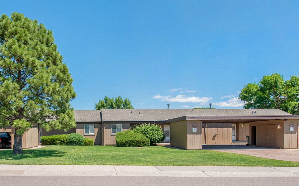 the view of a home with a lawn and trees