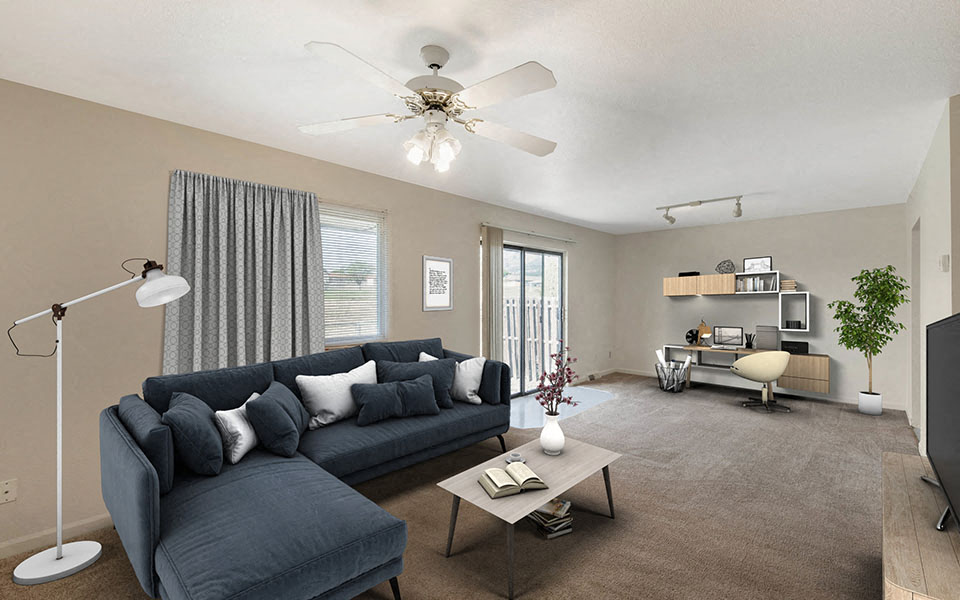 a living room with a couch and a ceiling fan