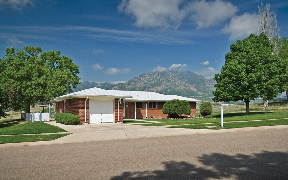 a house in a neighborhood with mountains in the background