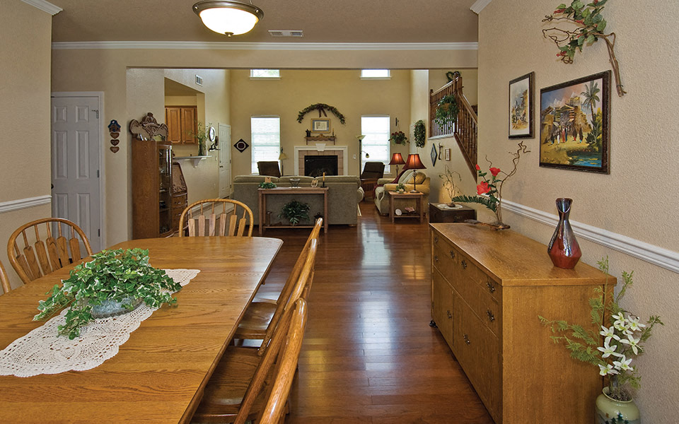 a dining room and living room with a table and chairs
