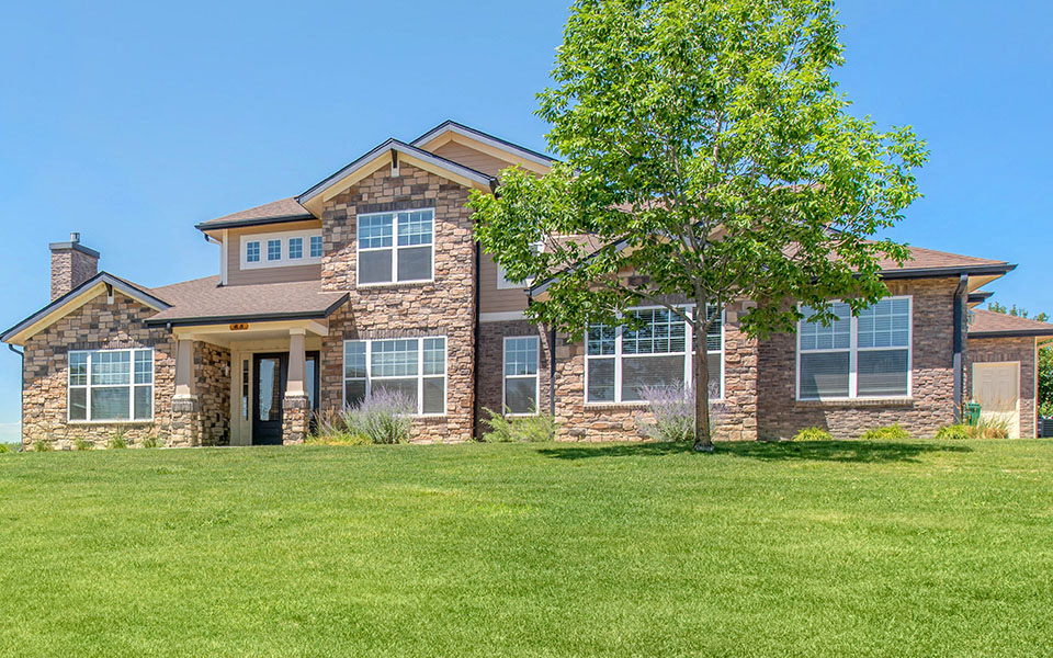 a large house with a lawn in front of it