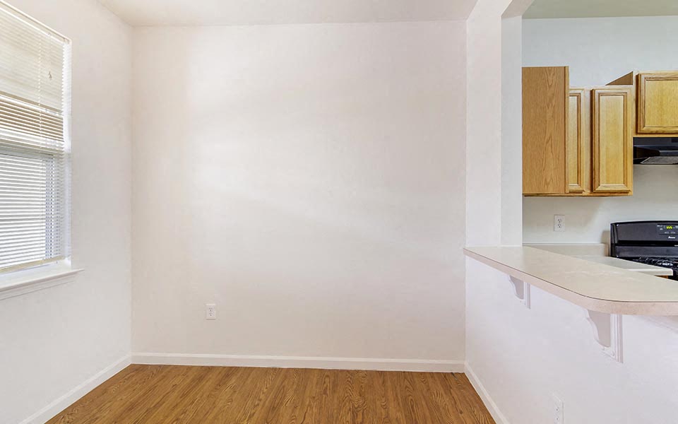 an empty kitchen with a counter and a window