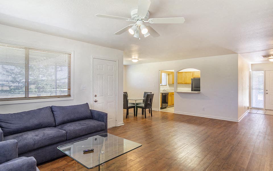 a living room with a couch and a glass table