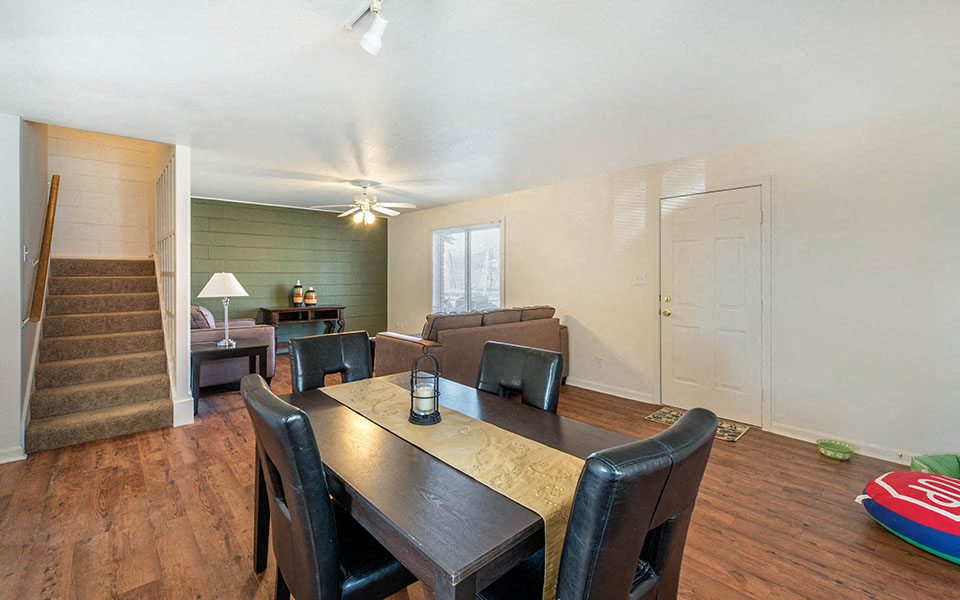 a dining room and living room with a table and chairs