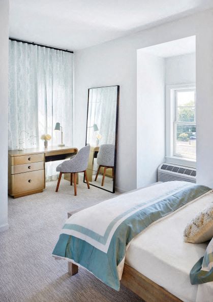 a bedroom with a bed and a mirror