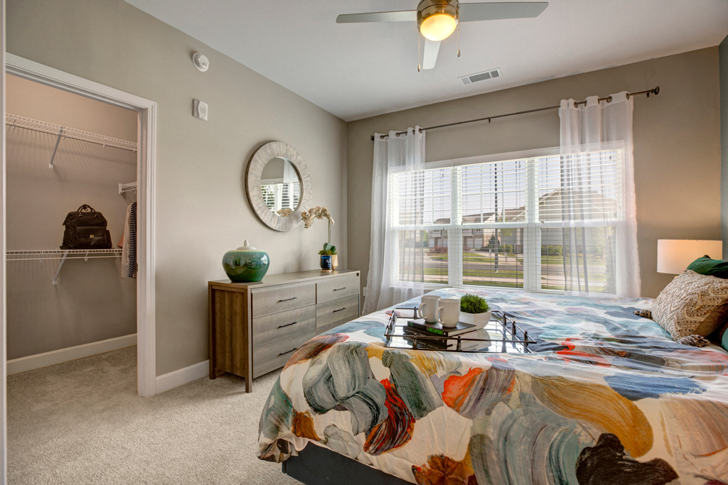 Big bedroom, Dresser, nightstands, carpet and walk in closet at Ascent at Mallard Creek Charlotte, NC