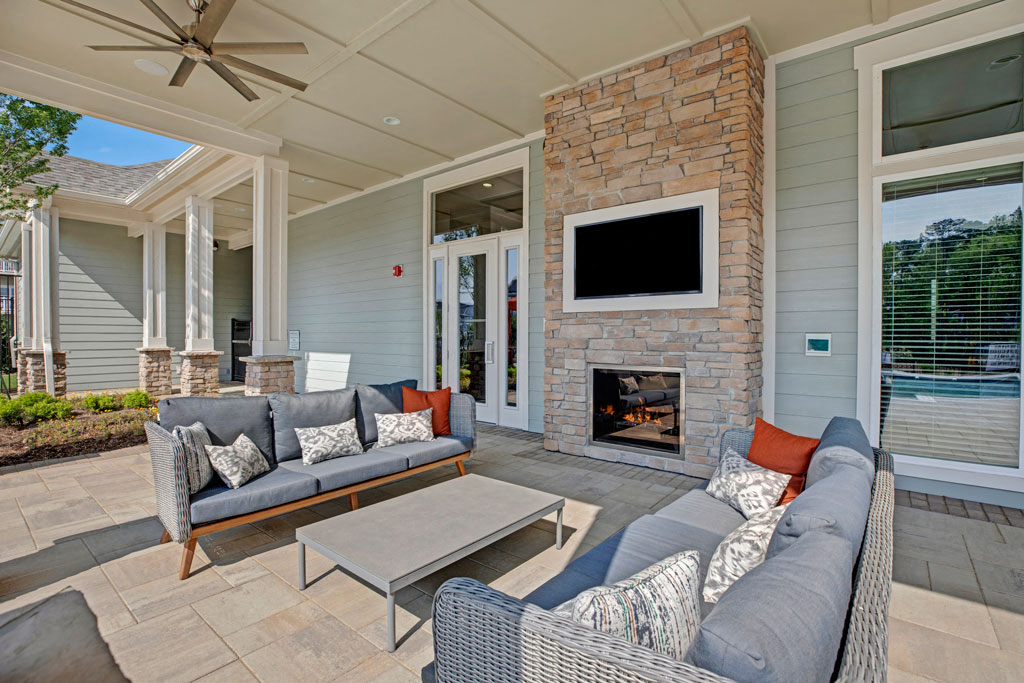 Living room decor at Ascent at Mallard Creek Apartment Homes, couches, table, fireplace, and a tv.