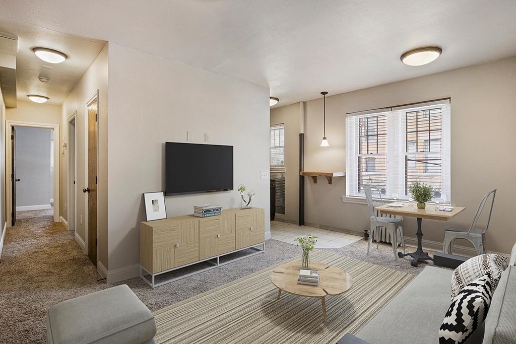 a living room and dining room with a television