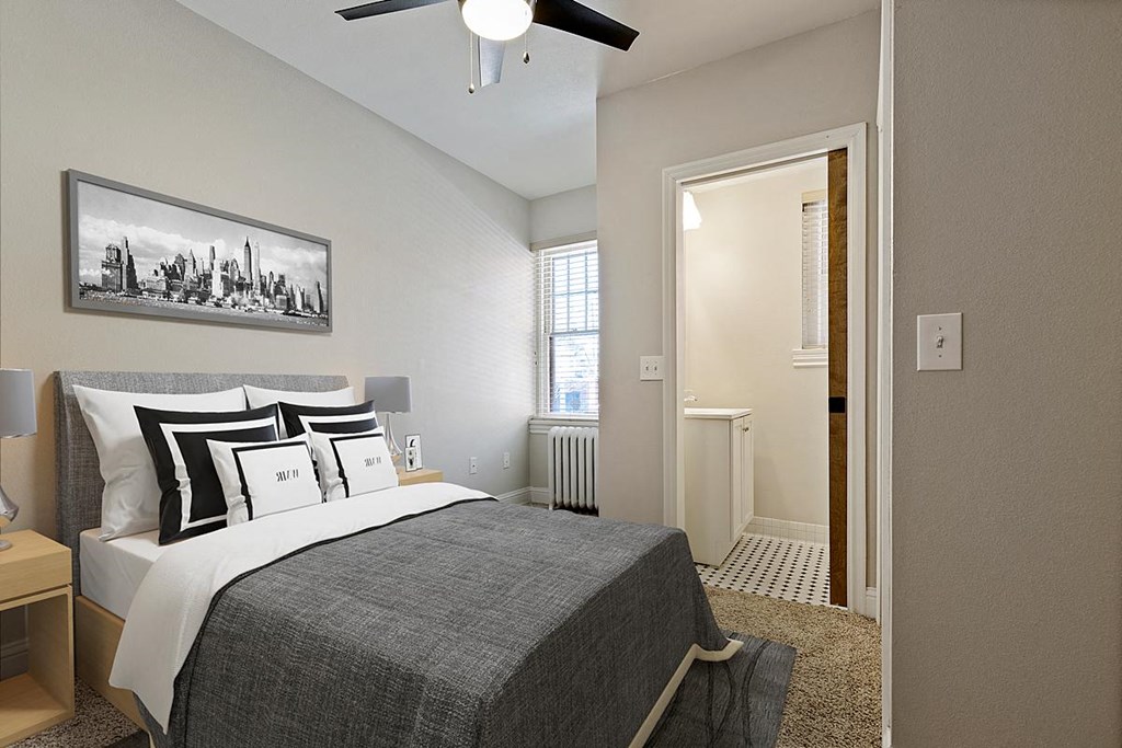 a bedroom with a bed and a ceiling fan