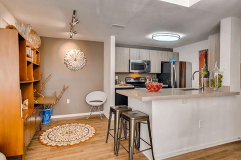 a kitchen with a bar and a counter top