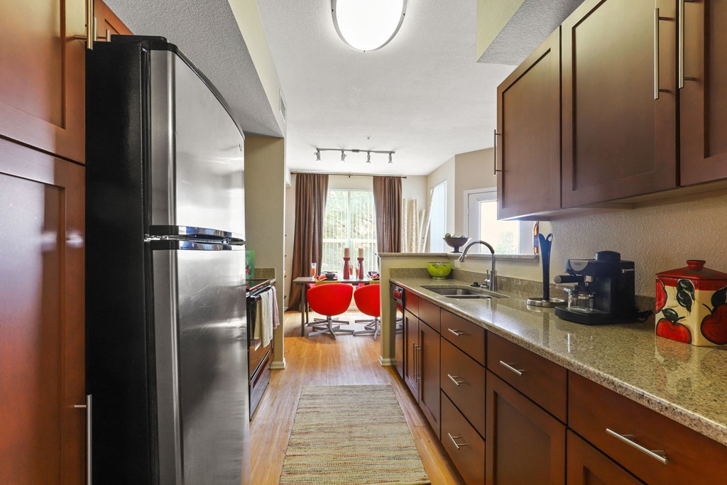 a kitchen with stainless steel appliances and granite counter tops