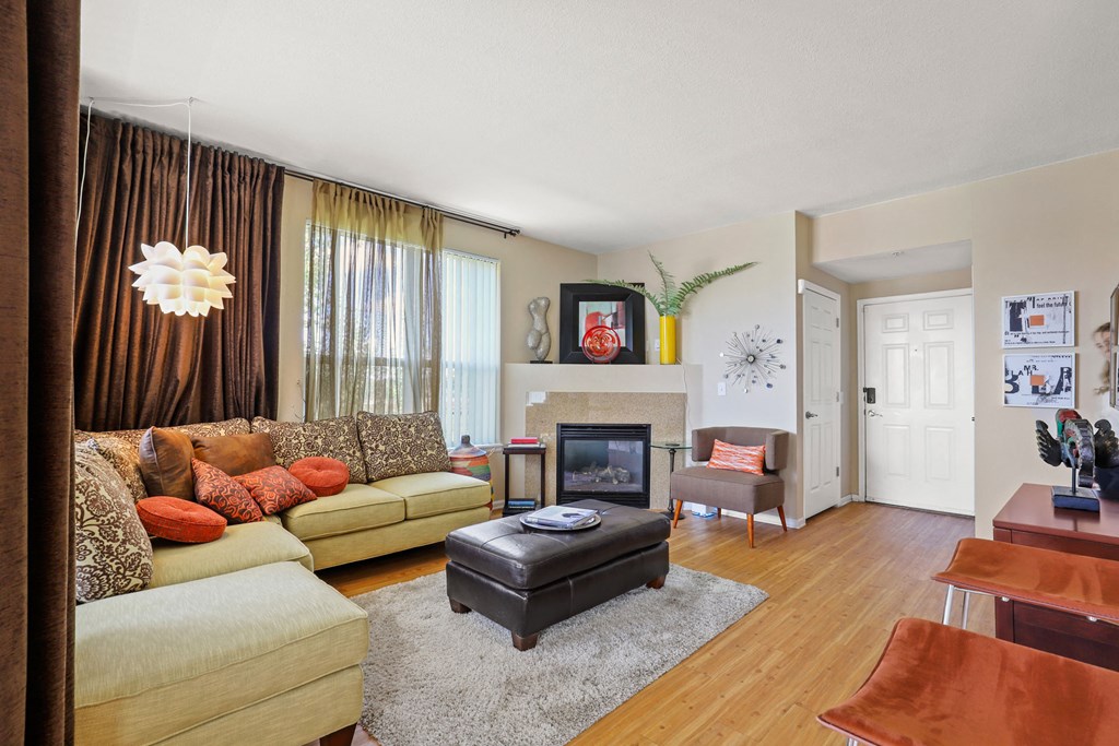 a living room with a couch and a chair and a fireplace