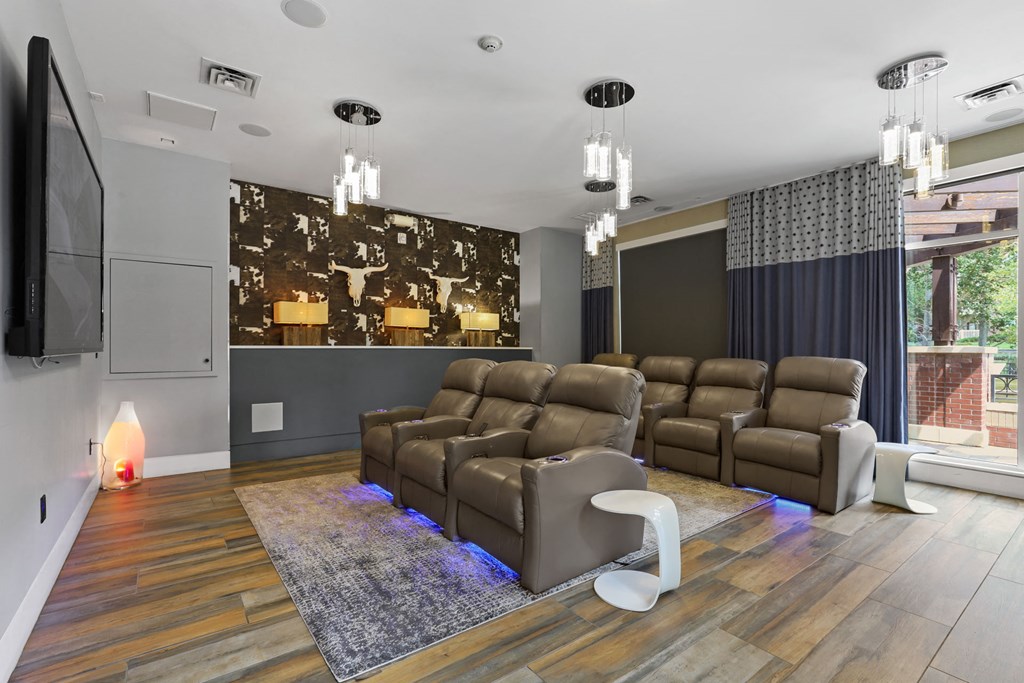 a living room with leather couches and a tv