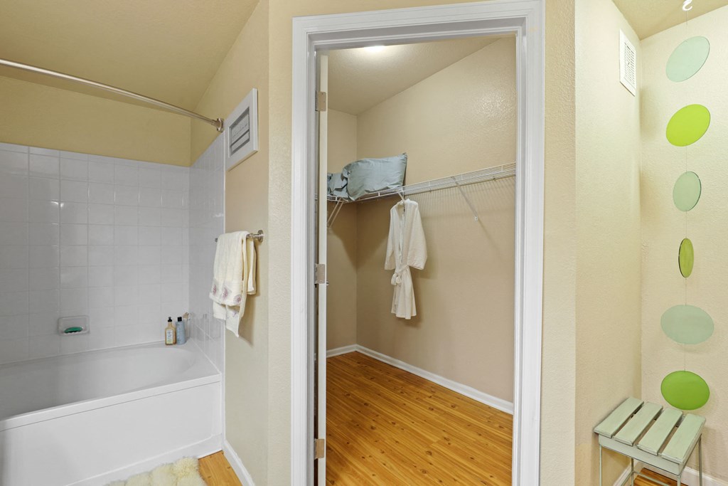 a bathroom with a shower and a tub and a mirror