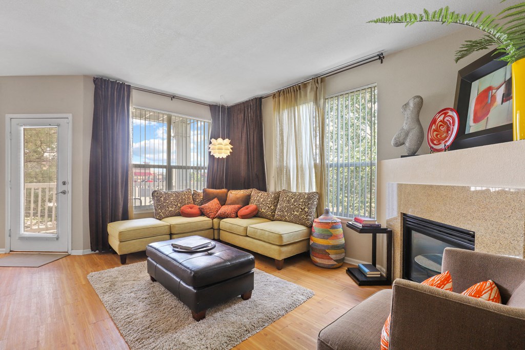 a living room with a couch and a chair and a fireplace