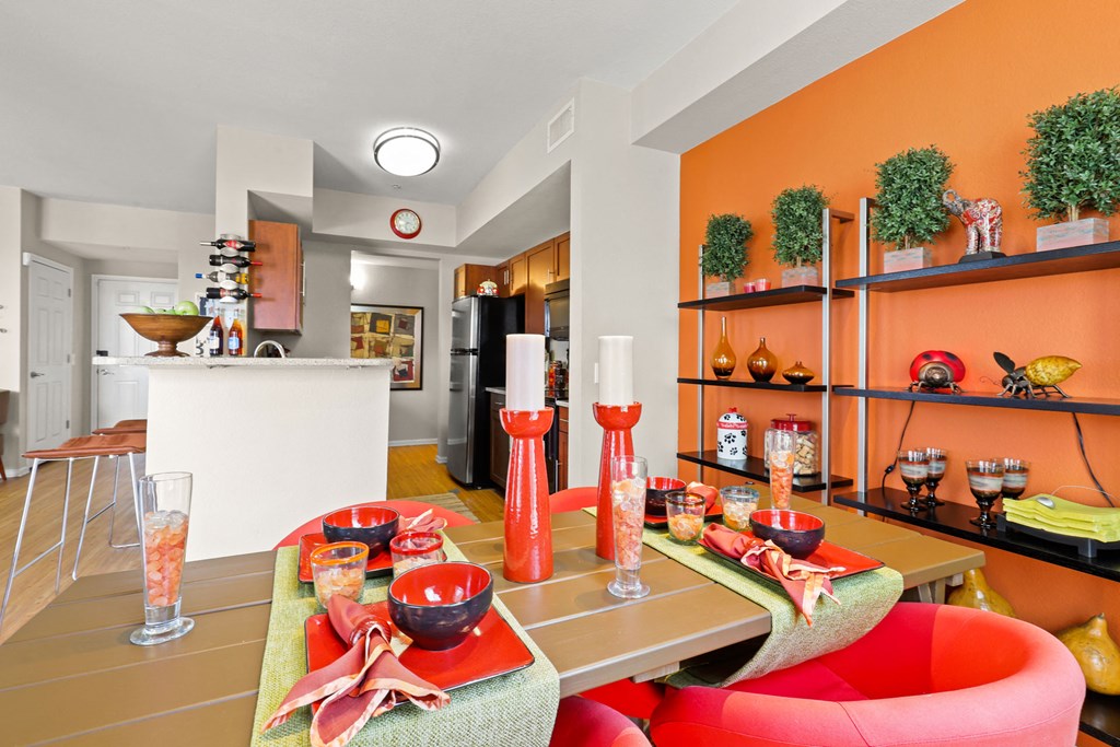 a living room with a table and chairs and a kitchen