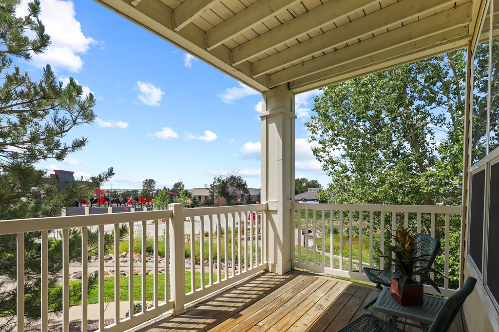 the view from the porch of a house with a wooden deck