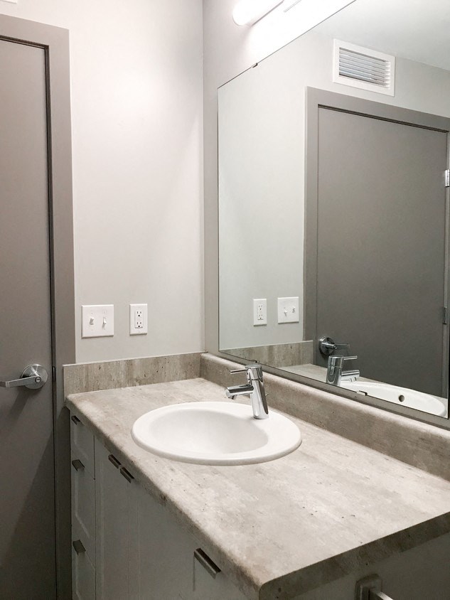 a bathroom with a sink and a mirror