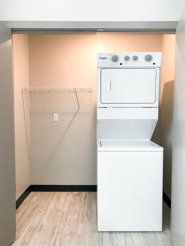 an empty laundry room with a washer and dryer