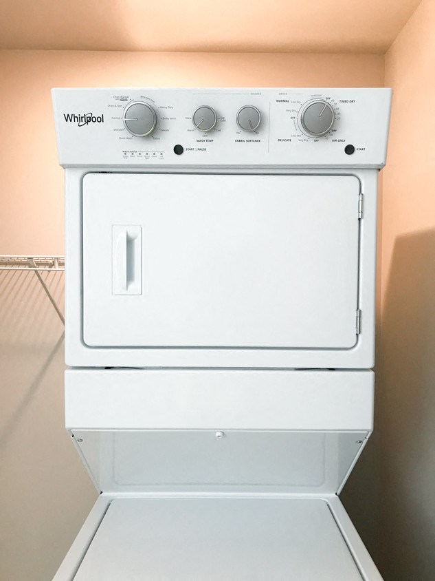 a white stove top oven sitting on top of a refrigerator