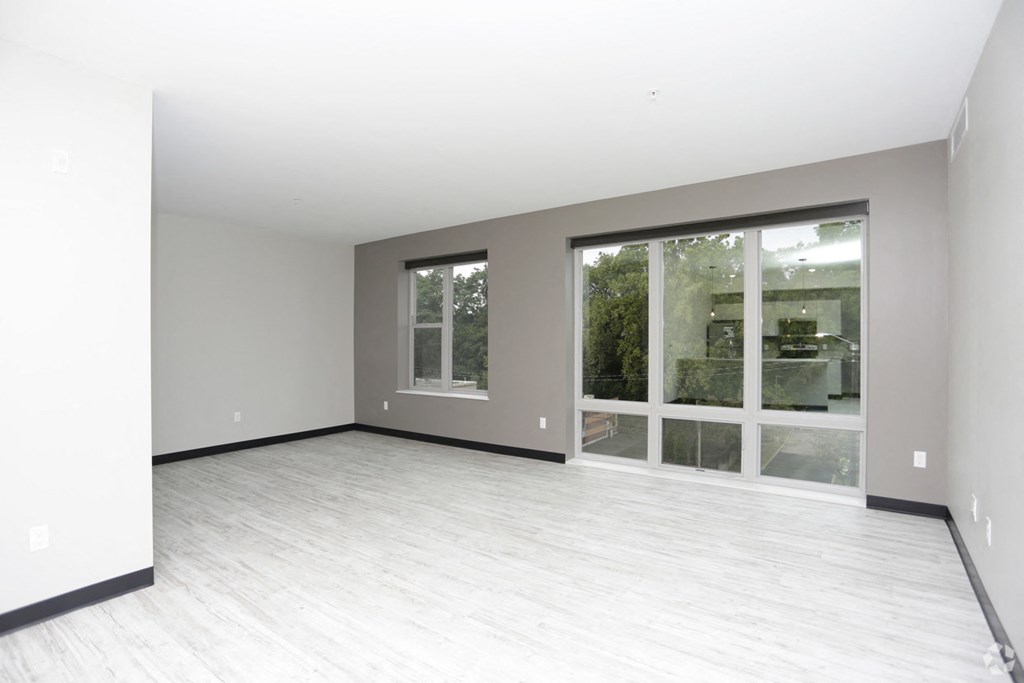 the living room of an empty house with a large window