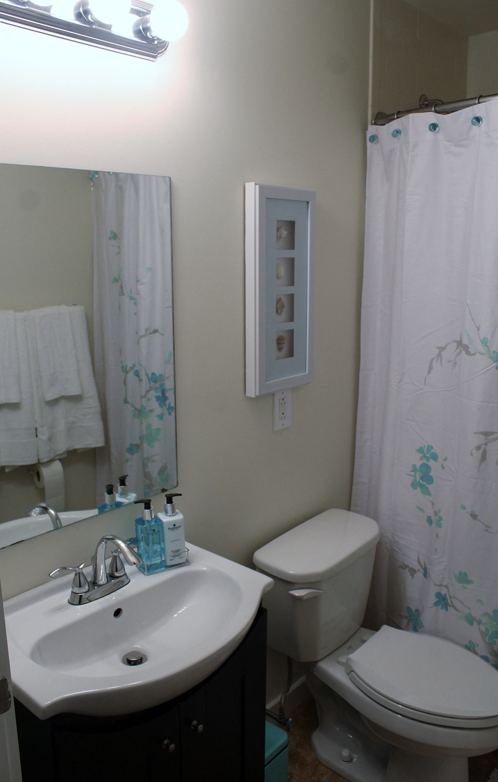 a small bathroom with a sink toilet and shower