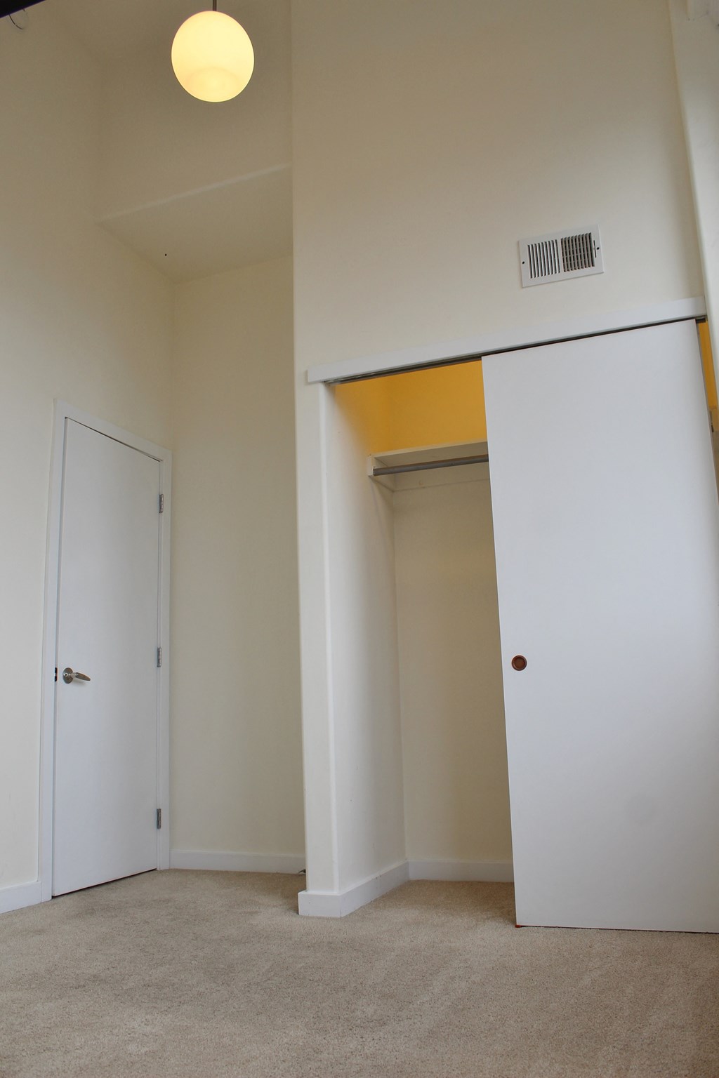 a bedroom with a closet and a door to a bathroom