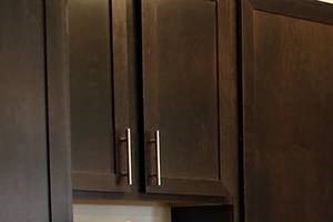 Kitchen with Open Floor Plan and SS Appliances a kitchen with black cabinets and a white counter top