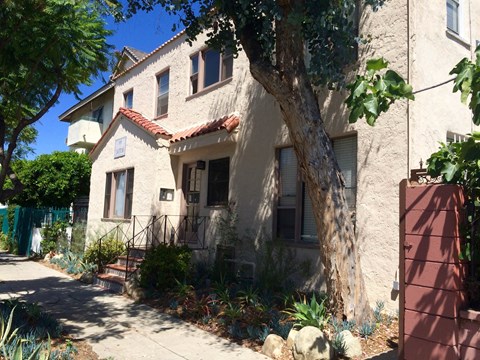 A house with a tree in front of it.